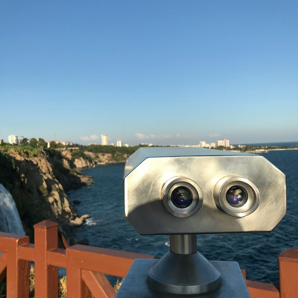 a pair of binoculars sitting on top of a wooden fence