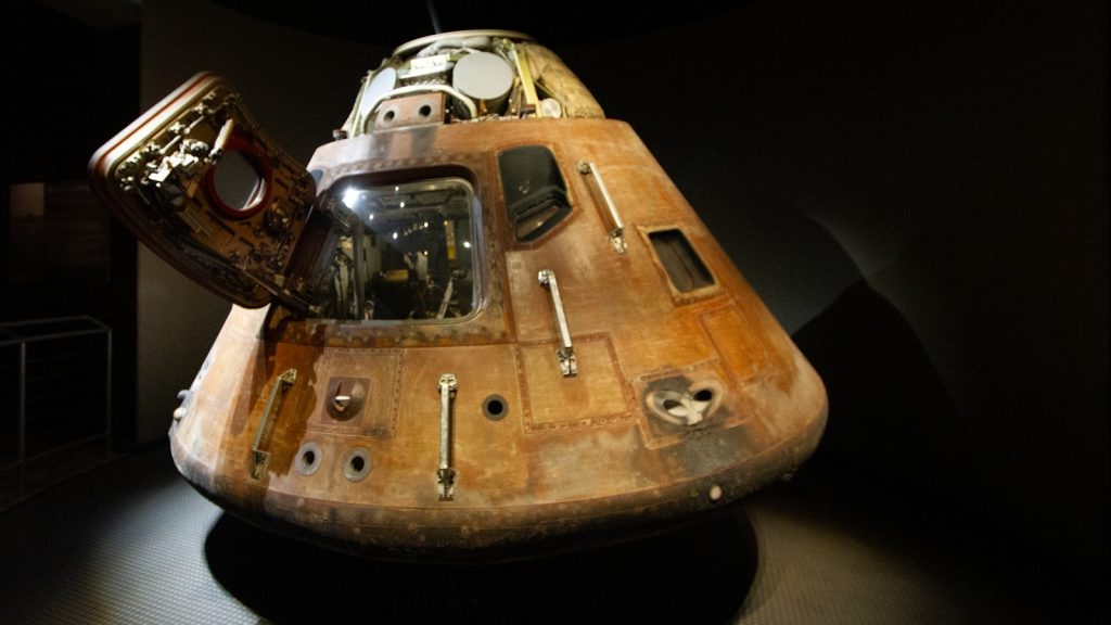 A wooden model of a space shuttle on display