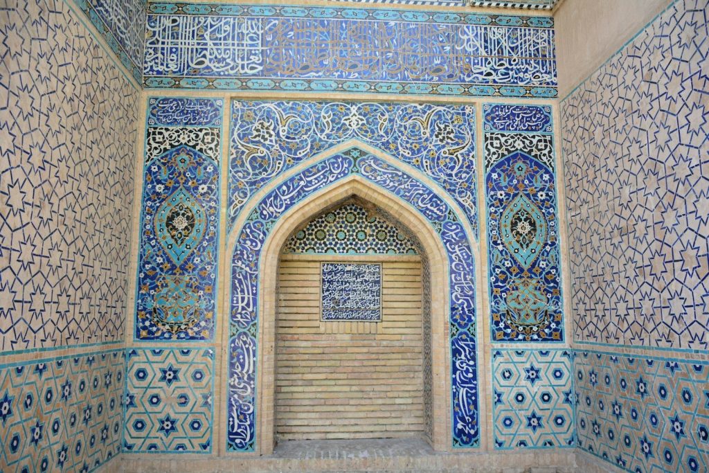 Ornate blue tilework adorns an arched entryway