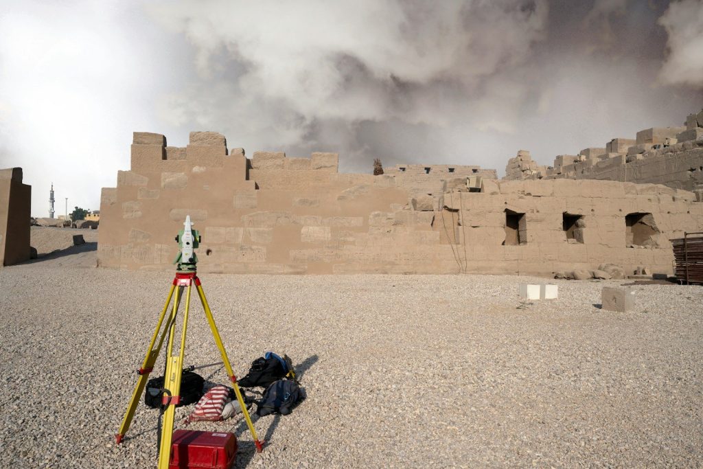 Surveying equipment set up at ancient ruins