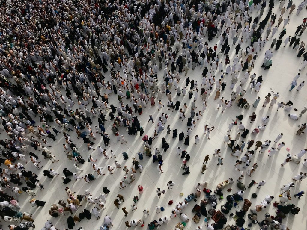 a large group of people standing in a large room